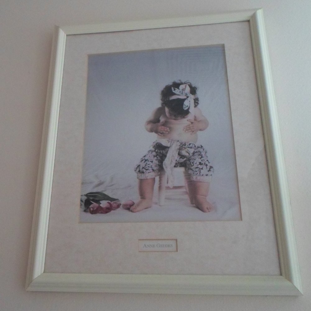 Anne Geddes Framed Print – Baby Sitting on Stool Navel Gazing